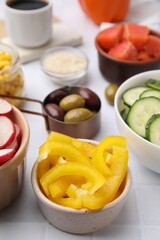 Ingredients for poke bowl on white checkered table