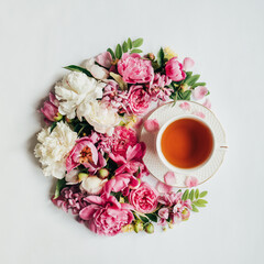 top view of arranged flowers and cup of hot tea