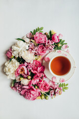 top view of arranged flowers and cup of hot tea