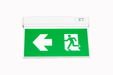 Fire exit green emergency exit signs isolated on white background. Warning plate with running man icon and arrow to left way. Fire escape sign hang on ceiling in the dark building near stairway.