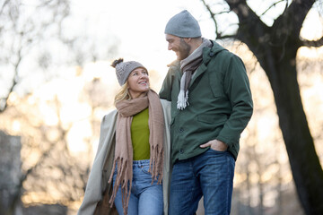 Embraced romantic couple enjoying a walk in the park