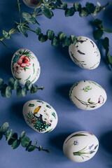 Easter eggs with floral ornament on blue table