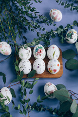 Easter eggs with floral ornament on blue table