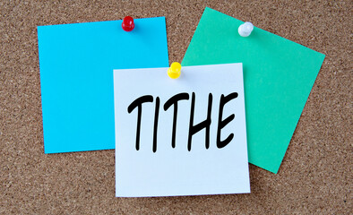 TITHE - word on colorful pieces of paper attached to the note board