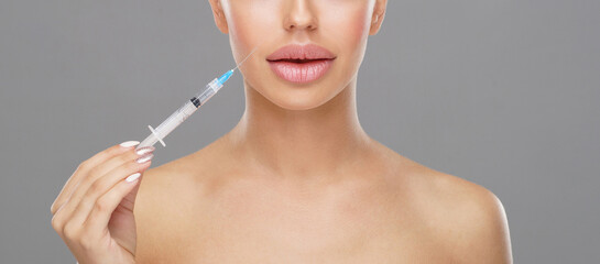 Beauty injection in a face of a young woman. Plastic surgery concept.