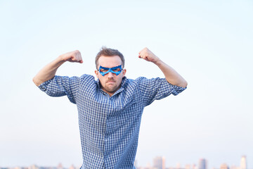 Pumped fists or superpower, aggression emotion concept. Caucasian angry man in nightwear shirt and...