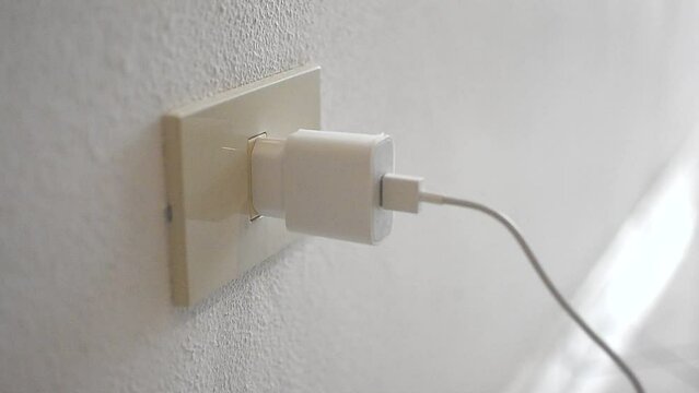 USB power socket, charging of flat phone battery. Insert the white plug into the socket by hand.