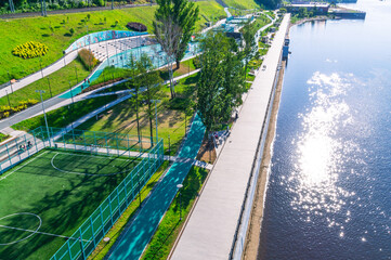 Outdoor recreation.Summer embankment by the river.The territory for recreation in the city.People...