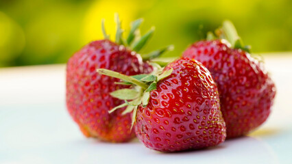 Red strawberries on white wooden table