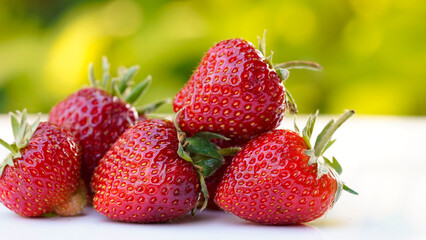 Red strawberries on white wooden table
