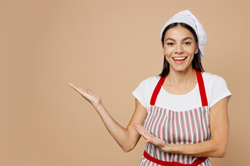 Young housewife housekeeper chef cook baker latin woman wear striped apron toque hat point hands...