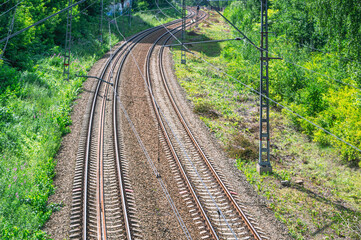 Railway and forest on the side of the road. Rails and sleepers of the railway track. Top view of the railway track. Long-distance transport links. Railway.