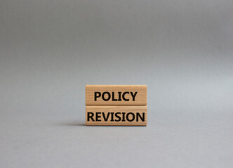 Policy revision symbol. Concept word Policy revision on wooden blocks. Beautiful grey background. Business and Policy revision concept. Copy space