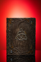 A magic book on a red background.