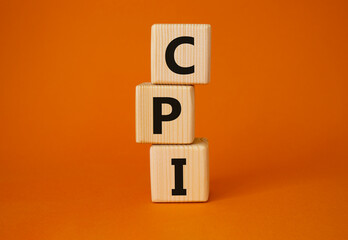 CPI - Consumer Price Index symbol. Concept word CPI on wooden cubes. Beautiful orange background. Business and CPI concept. Copy space.