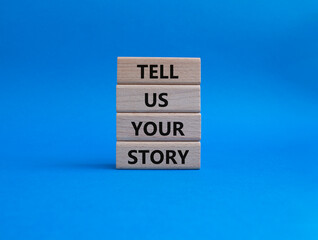 Tell us your story symbol. Concept words Tell us your story on wooden blocks. Beautiful blue background. Business and Tell us your story concept. Copy space.