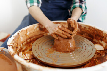 Cropped Image of Unrecognizable Female Ceramics Maker working with Pottery Wheel in Cozy Workshop Makes a Future Vase or Mug, Creative People Handcraft Pottery Class
