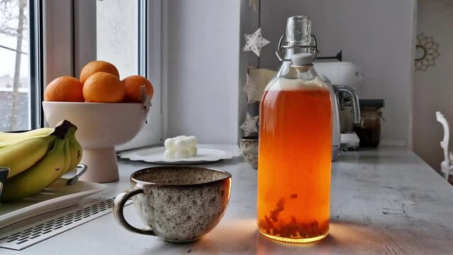 Opening a bottle of home made kombucha from the black tea. Second fermentation - fuzzy healthy drink