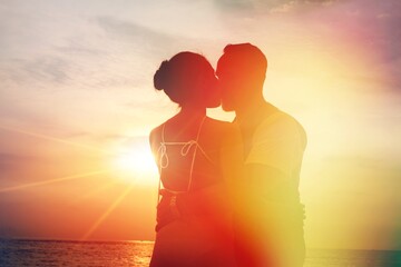 Silhouette sunset : Senior business man and his wife hugging and kissing on celebration event at the yacht deck,Silhouette romance scene marriage anniversary over sunset, luxury and happiness moment - obrazy, fototapety, plakaty
