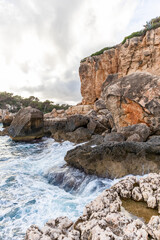 Fototapeta na wymiar Cliffs, beaches and coves in the south of the island of Mallocar in the Balearic Islands in Spain. Mediterranean coast.