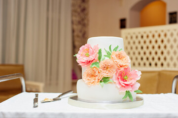 Big wedding cake decorated with flowers.