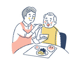 シニア男性の食事介助をしている介護スタッフ