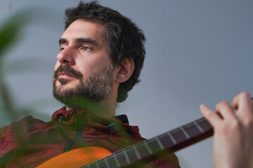 young bearded man playing the Spanish guitar