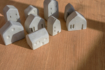 Mini house models on wood table, selective focus, Planning to buy property. Choose what's the best. A symbol for construction ,ecology, loan concepts