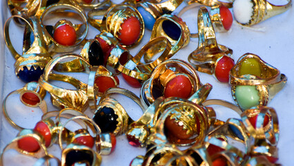 Close up of Gold plated unisex Multi Gemstone Rings kept for selling in Indian market