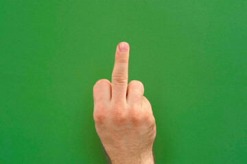 Abusive gesture fuck on chromakey. Male hand shows middle finger, offensive gesture isolated on...