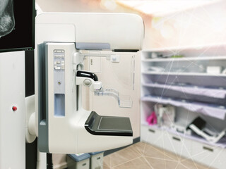 Mammography machine with monitor  for breast screening device on mammogram room background.