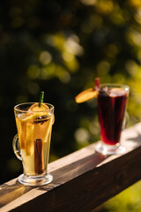 Hot mulled wine in a glass with chopped fruits and star anise and cinnamon