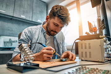 Portrait of a man repairing microcircuits.Concept of engineering, chip development and service.