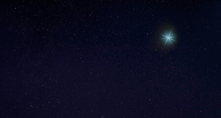 Obraz na płótnie Canvas Bright blue light in the sky on a starry night