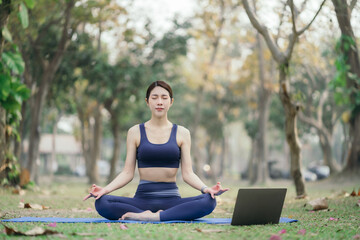 Young woman asian practicing breathing exercise at Park near the house.