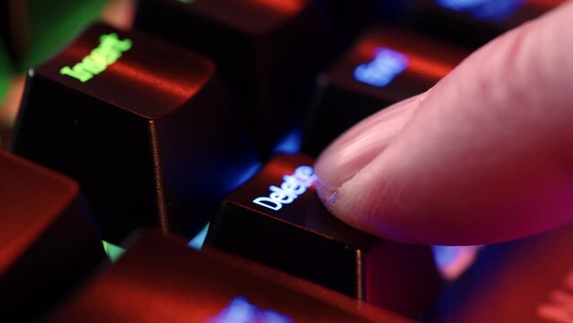 Person is in doubt whether to press the Delete key or not. The finger hovers over the Delete key for a few seconds before deciding to press it. Yes or no concept. A heavy dicision do it or not.