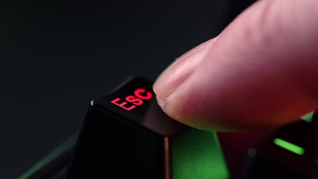 Person is in doubt whether to press the Escape key or not. The finger hovers over the Escape key for a few seconds before deciding to press it. Yes or no concept. A heavy dicision do it or not.