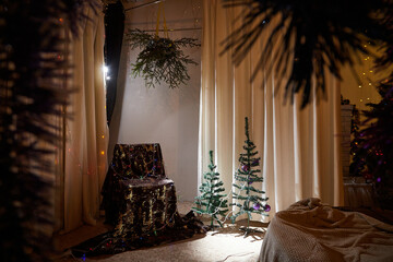 Interior decorated for Christmas and New Year with cristmas tree and chair in beautiful room. Location for a photo shoot in the studio