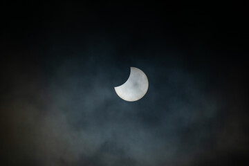 Obraz na płótnie Canvas Partial Solar Eclipse on a Cloudy Day