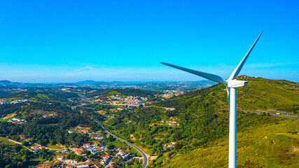 Wind turbine on the background of a small European city, a close-up view. The concept of clean Renewable energy.