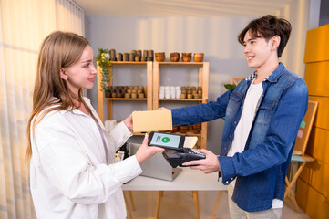 woman customer using QR code payment via smartphone for paying at shop