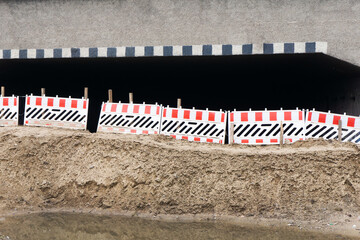Closed tunnel background. Closed road barriers. Flooded road dangerous construction. Earthquake...
