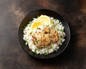 Grilled Chicken thighs served with rice in a black bowl