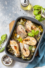Healthy baked fish salmon steaks with basil, green beans, sweet peppers and onions. Cooking a delicious low carb dinner, healthy nutrition concept, diet menu. View from above. Copy space.
