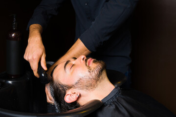 Attractive man relaxing while preparing to have a haircut