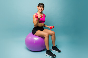 Latin fitness woman smiling looking happy working out