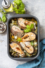 Healthy baked fish salmon steaks with basil, green beans, sweet peppers and onions. Cooking a delicious low carb dinner, healthy nutrition concept, diet menu. View from above.