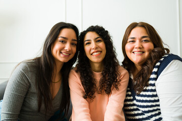 Portrait of three female friends looking happy