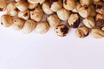 Peeled hazelnuts on a white background. Poorly peeled hazelnuts. Background of peeled hazelnuts.