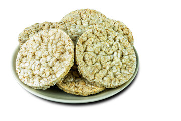 Wheat crumbs on a plate on a white background